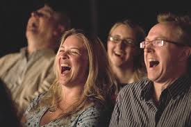 Packed audience enjoying a live stand-up comedy show at JK Comedy Club