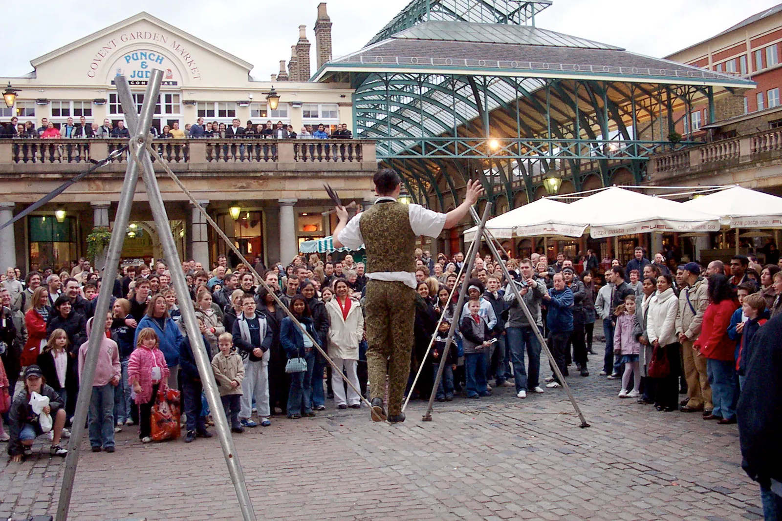 Street performer entertaining a crowd in Covent Garden