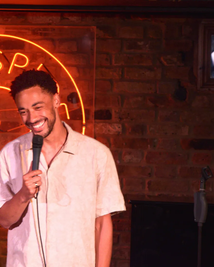 Comedian performing live stand-up on stage at JK Comedy Club