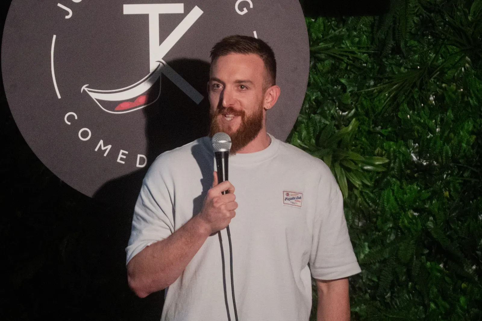 Comedian performing live stand-up on stage at JK Comedy Club Covent Garden, Arboretum