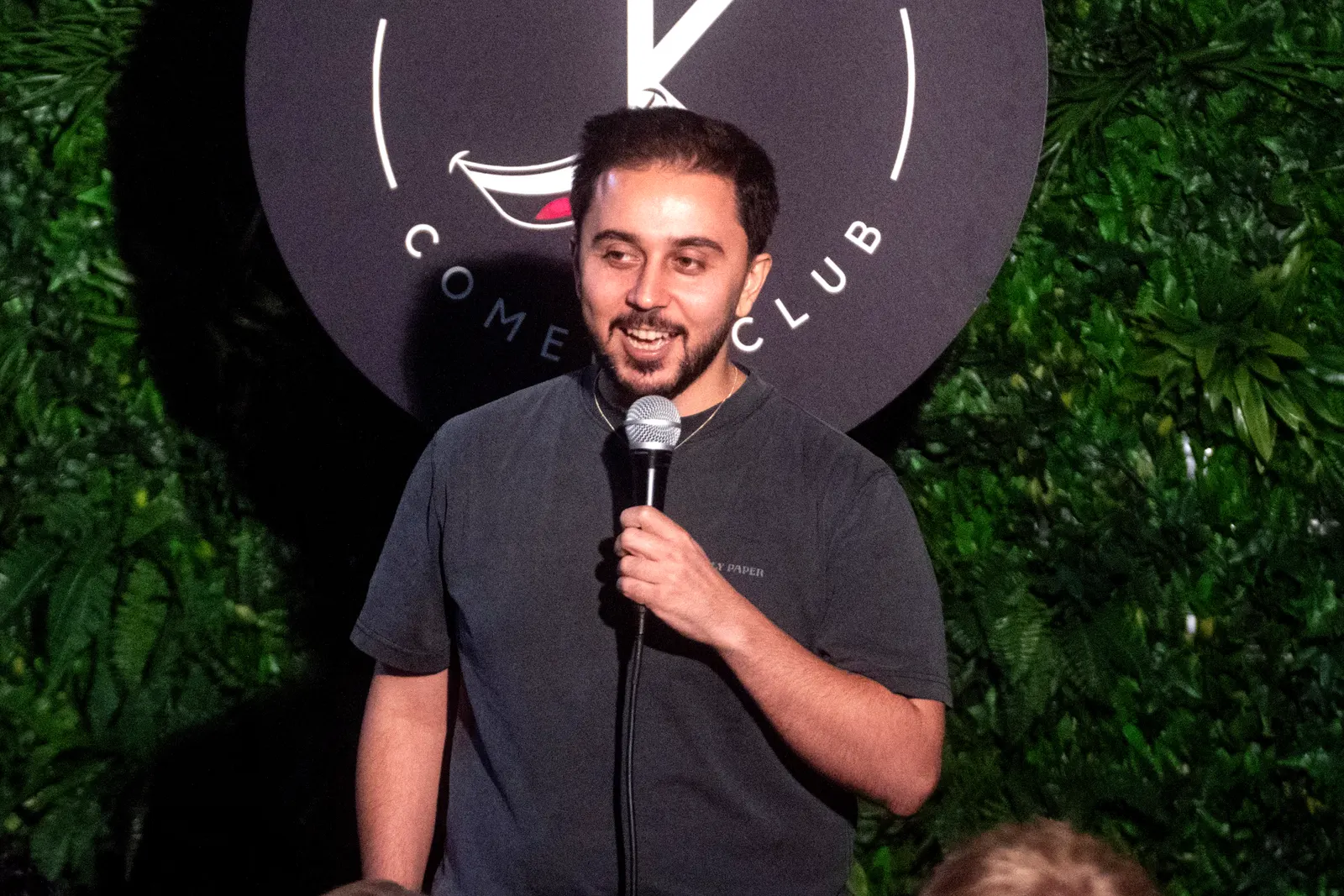 Comedian performing live stand-up on stage at JK Comedy Club Covent Garden, Arboretum