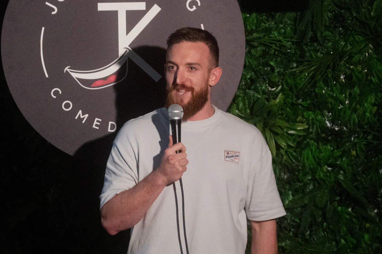 Comedian performing live stand-up on stage at JK Comedy Club Covent Garden, Arboretum