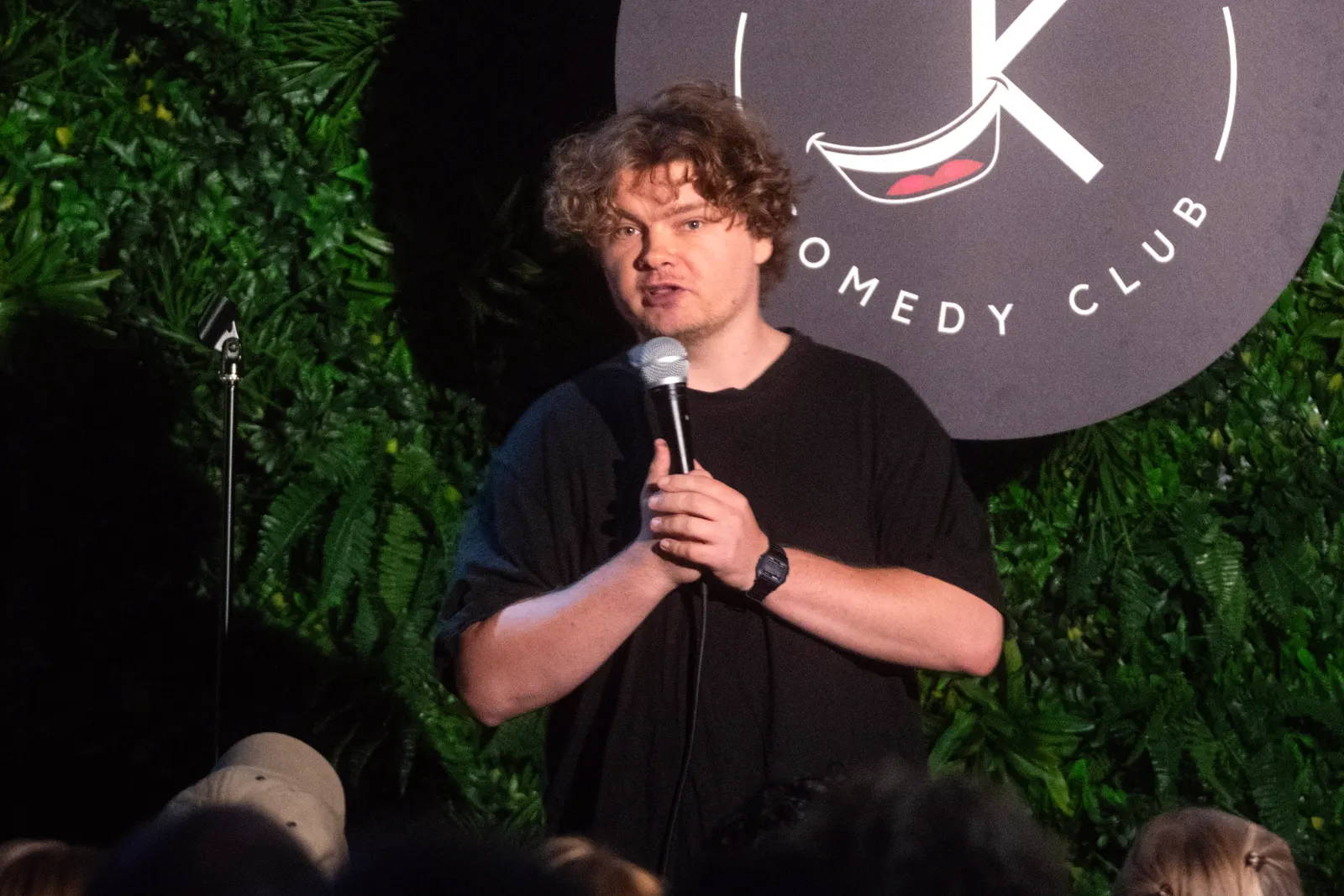 Comedian performing live stand-up on stage at JK Comedy Club Covent Garden, Arboretum