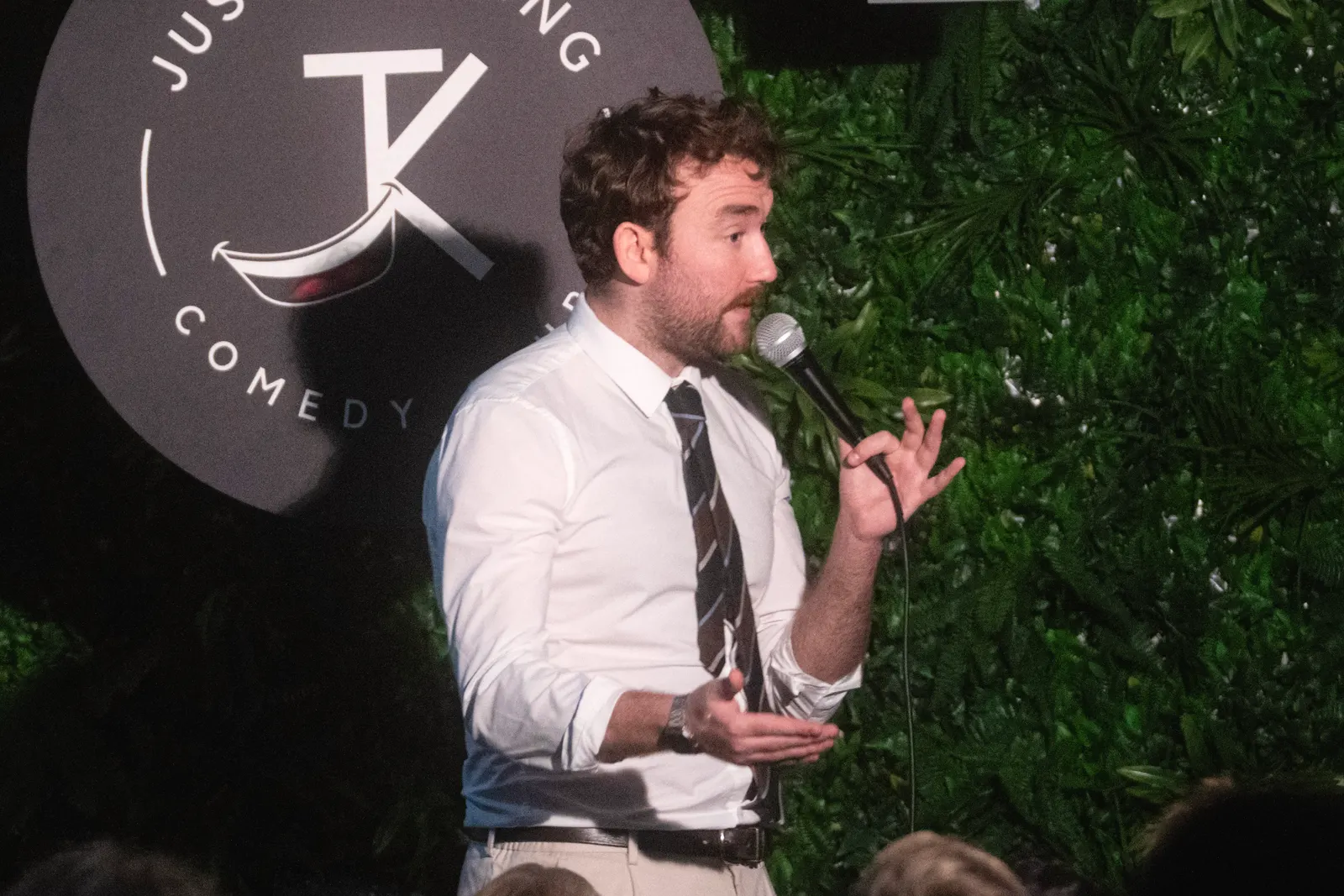 Comedian performing live stand-up on stage at JK Comedy Club Covent Garden, Arboretum