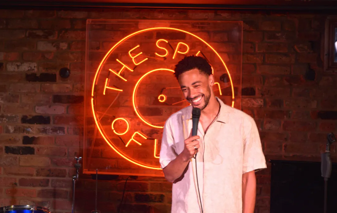 Comedian performing live stand-up on stage at JK Comedy Club Soho on a Saturday afternoon