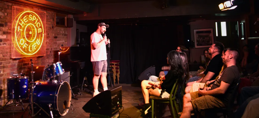 Comedian on stage with the Saturday afternoon audience at JK Comedy Club Soho